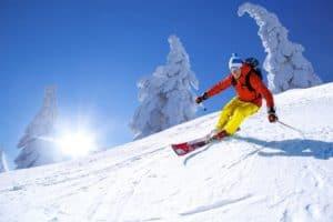 A man skiing down a snow covered mountain.