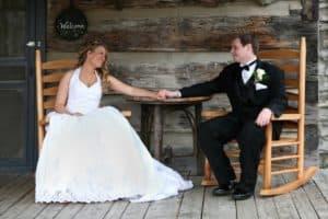 Bride and groom posing on the porch for their Gatlinburg cabin wedding