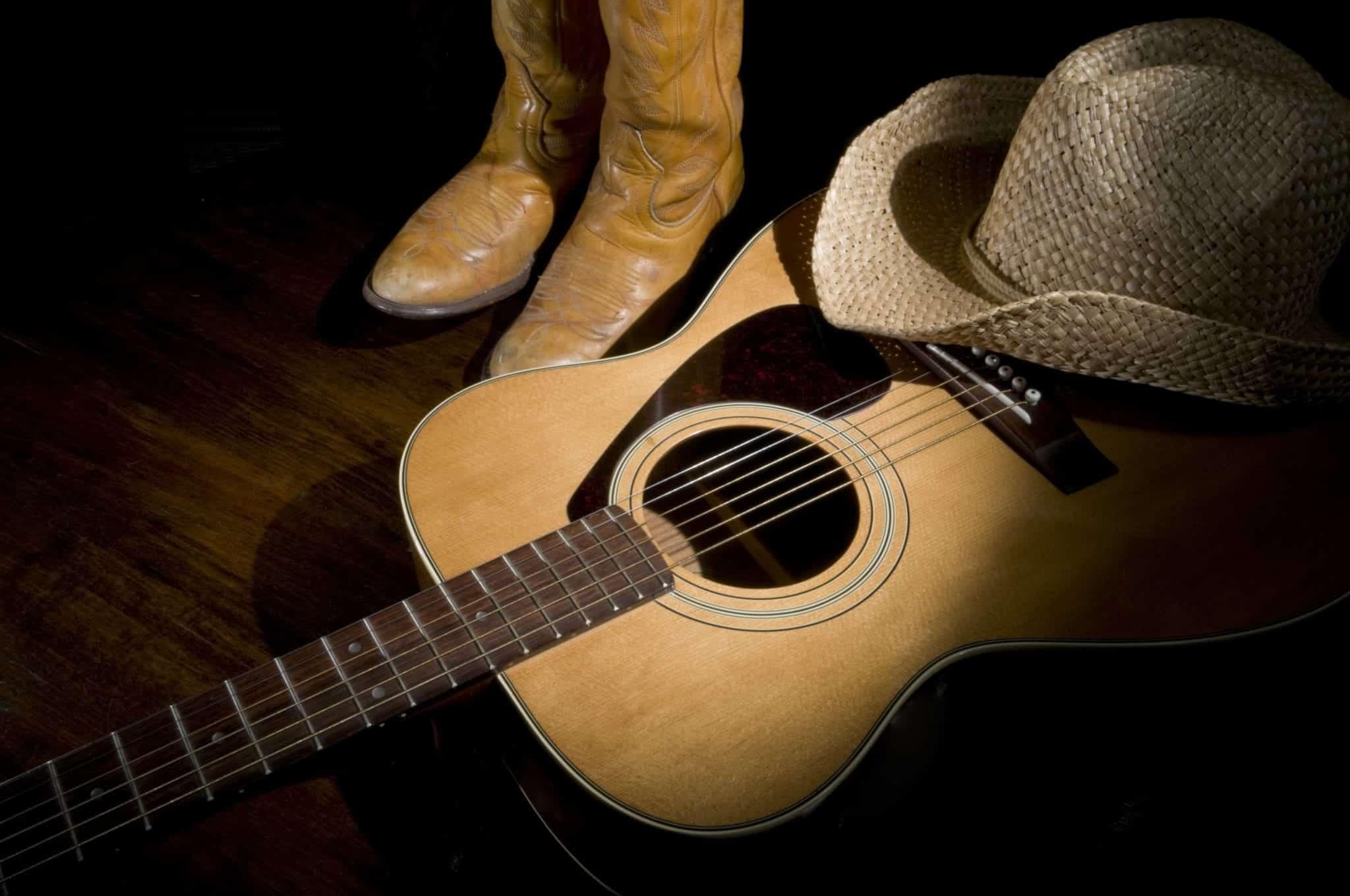 Country music cowboy hat, cowboy boots, and guitar
