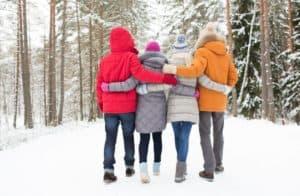 Group of friends going hiking in the snow