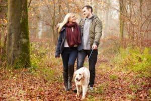 Happy couple walking with their dog near our Smoky Mountain getaway cabin rentals.