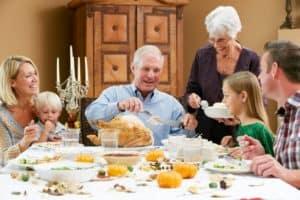 Multi-generational family enjoying a delicious Thanksgiving meal.