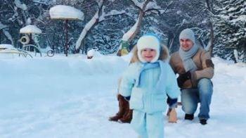 stock-footage-slow-motion-portrait-of-a-young-family-with-their-baby-in-a-winter-park-a-child-sits-on-a-sled.jpg